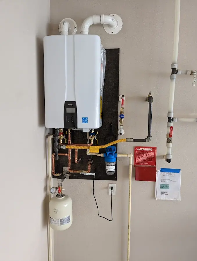 Professional plumber installing copper piping in a Hightstown home